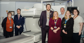 Staff from the Trust and partner organisations posing for a photo alongside the new CT scanner.