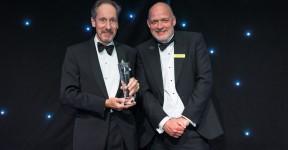 Dr Turvill collecting his award from Simon Morritt.