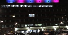 York Hospital main entrance with its external lights turned pink and blue.