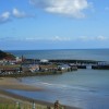 Part of Scarborough beach and town on a sunny day.