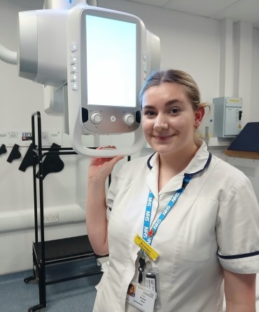 Bronwyn at work next to an x-ray machine.