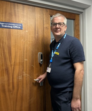 David at the entrance to Scarborough Hospital's Digital and Information Service Training Office.