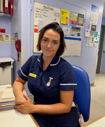 Faith at work, sitting at the nurses station on Ward 16.