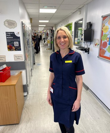 Gemma standing on a hospital corridor.