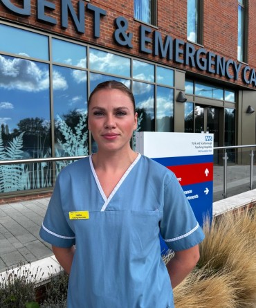 Hattie in front of Scarborough Hospital's Urgent and Emergency Care Centre main entrance.
