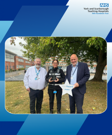 Star Award winner Jodie Clarke receiving her award from Simon Morritt, Chief Executive, and another member of the security team