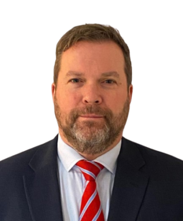 Headshot of Chris Norman, wearing a suit and a tie.