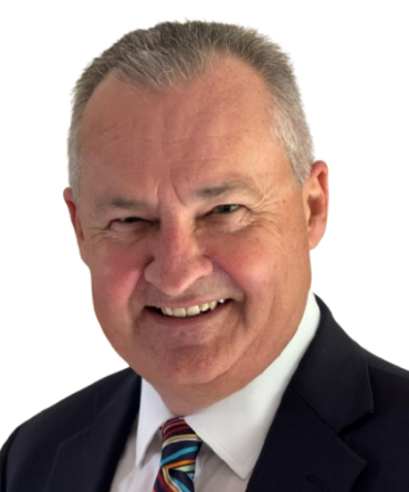 Headshot of Noel Scanlon, wearing a suit and a tie. Noel is smiling.