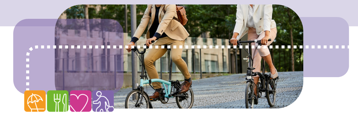 Image of two people cycling in urban setting