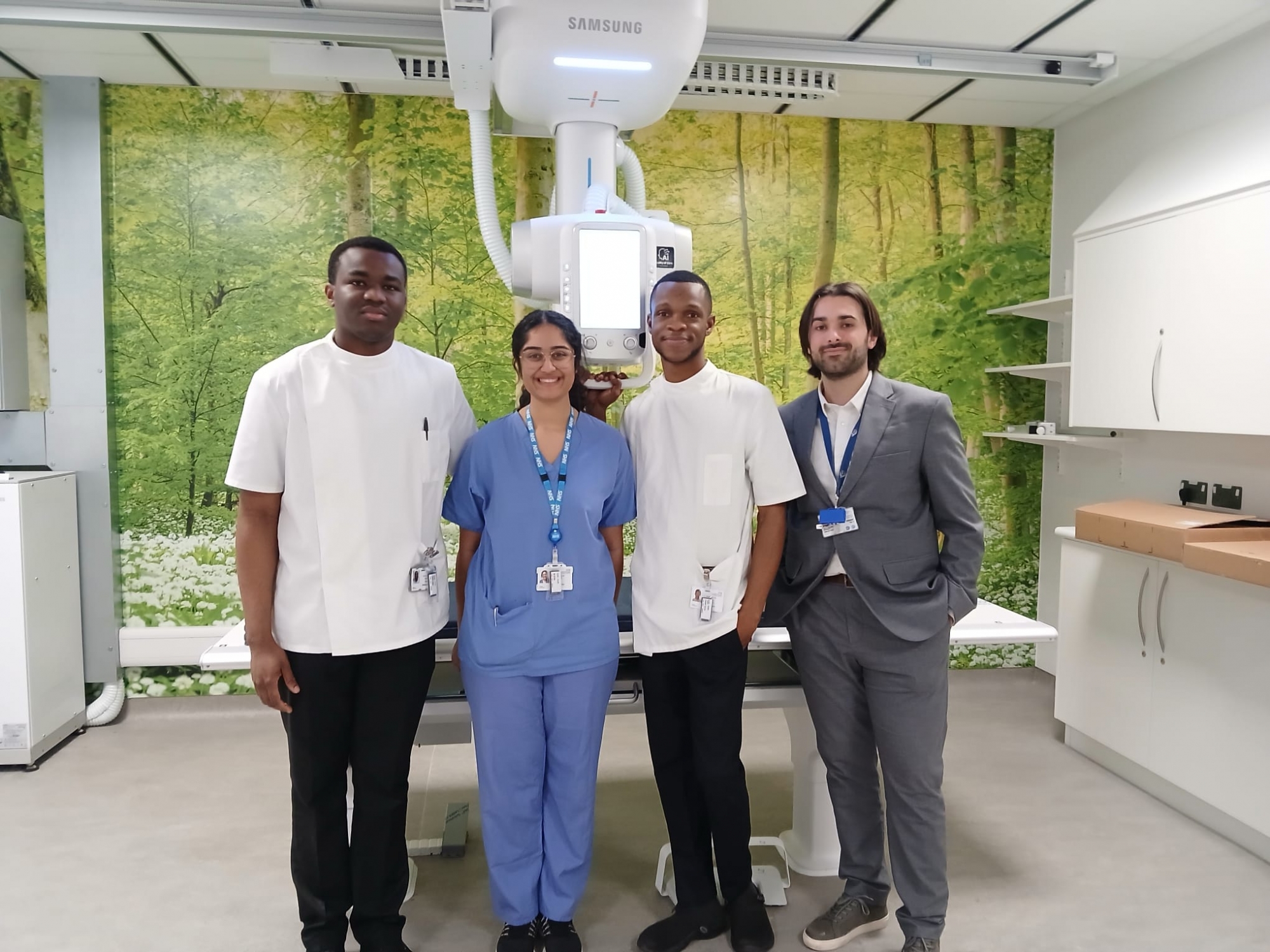 A group of people standing in an  imaging room.