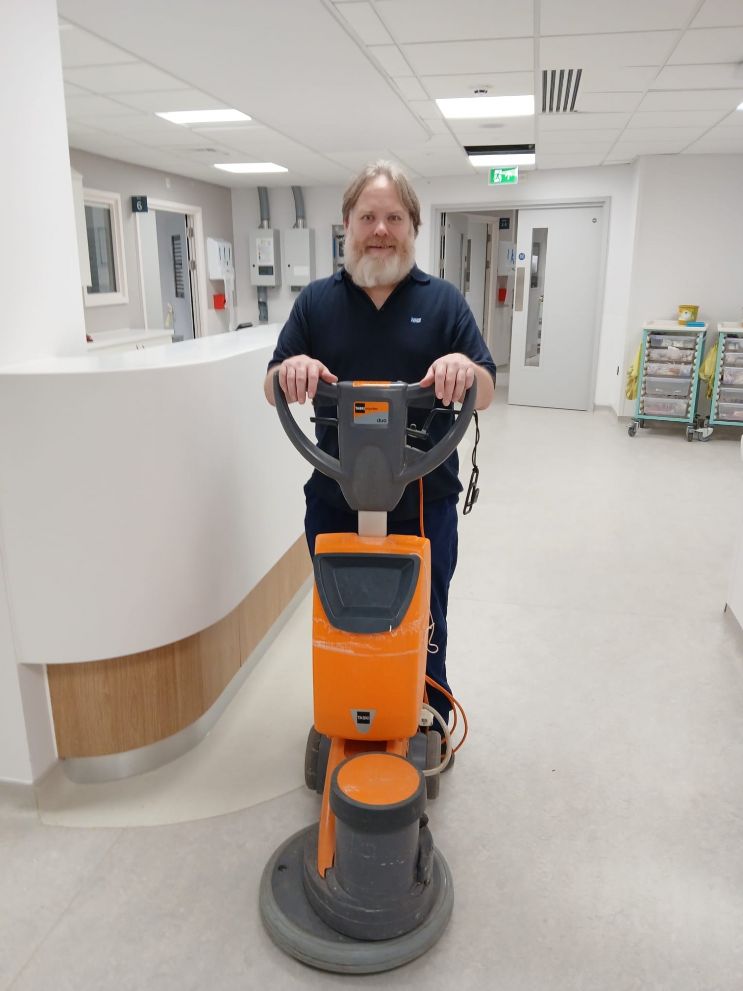 Gary Procter, Domestic Assistant, using a cleaning machine.